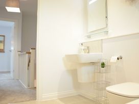 A bathroom with a sink and toilet at Lapwings, Aldeburgh