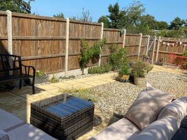 A garden with a bench and table at Lapwings, Aldeburgh