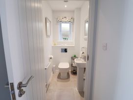 A bathroom with a toilet and sink at Lapwings, Aldeburgh