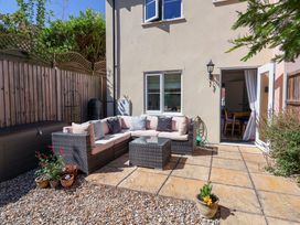 An outdoor seating area with a sofa and coffee table at Lapwings, Aldeburgh