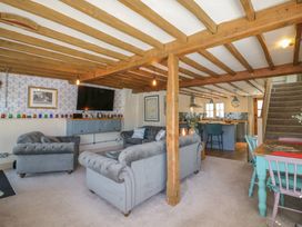 A living room with sofas and a kitchen area at The Annex in Cavendish Near Sudbury