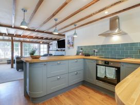 A kitchen with an island and oven at The Annex Cavendish Near Sudbury