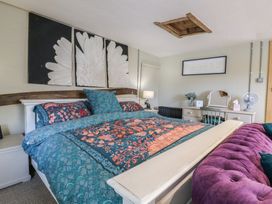 A bedroom with a bed and desk at The Annex in Cavendish Near Sudbury