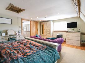 A bedroom with a bed, dresser, wardrobe and television at The Annex in Cavendish Near Sudbury
