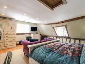 A bedroom with a bed and wardrobe at The Annex Cavendish Near Sudbury