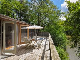 An outdoor space with seating and a river view at 11 Water's Edge near Pelynt