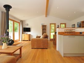 A living room with a stove and television at 11 Water's Edge near Pelynt