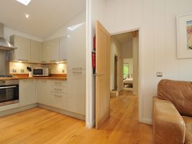 A kitchen with a door leading to other rooms at 11 Water's Edge near Pelynt