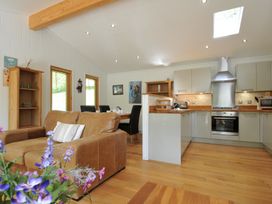 A kitchen with dining table and chairs at 11 Water's Edge near Pelynt