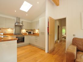 A kitchen with cabinets and countertops at 11 Water's Edge near Pelynt