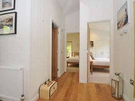 A hallway with paintings and a radiator at 11 Water's Edge near Pelynt
