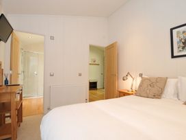 A bedroom with a bed and television at 11 Water's Edge near Pelynt