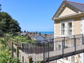 A view of a building with a pathway and ocean in the background at Sea Vista in Westward Ho!