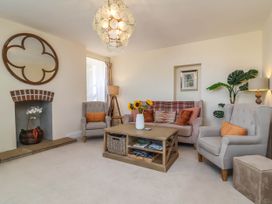 A living room with a coffee table and armchairs at Sea Vista in Westward Ho!