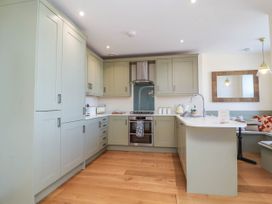 A kitchen with cabinets and appliances at Sea Vista in Westward Ho!