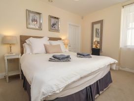 A bedroom with a bed and towels at Sea Vista in Westward Ho!