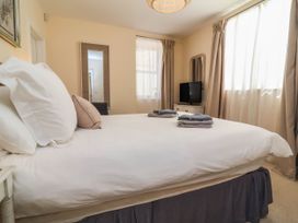A bedroom with a bed and television at Sea Vista, Westward Ho!