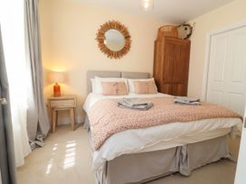 A bedroom with a bed and nightstand at Sea Vista in Westward Ho!