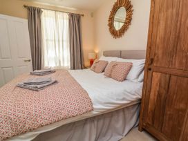 A bedroom with a bed and wardrobe at Sea Vista in Westward Ho!