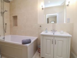 A bathroom with a bathtub, sink, and shower at Sea Vista in Westward Ho!