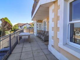 A balcony with a table and chairs at Sea Vista in Westward Ho!