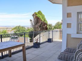 An outdoor terrace with a table and chairs at Sea Vista in Westward Ho!