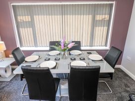 A dining table set with plates and glassware at Ger y Mynydd, 2 Cae  Ty Coch in Brynteg