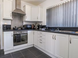 A kitchen with appliances and a countertop at Ger y Mynydd, 2 Cae Ty Coch Brynteg