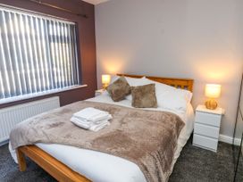 A bedroom with a bed and side tables at Ger y Mynydd, 2 Cae Ty Coch in Brynteg