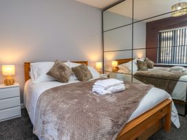 A bedroom with a bed and nightstands at Ger y Mynydd, 2 Cae  Ty Coch in Brynteg