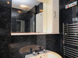 A bathroom with a sink and mirror at Ger y Mynydd, 2 Cae Ty Coch in Brynteg