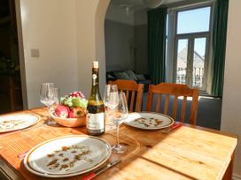 A dining room with a table set for dinner at Flat 3, 4 Park Road in Swanage
