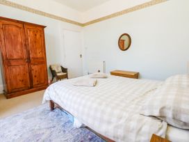A bedroom with a bed and wardrobe at Flat 3, 4 Park Road, Swanage