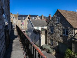 An outdoor view from a balcony showing buildings and a clear blue sky at Flat 3, 4 Park Road in Swanage