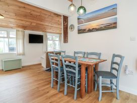 A dining room with a table and chairs at Dingle Dell in Braunton