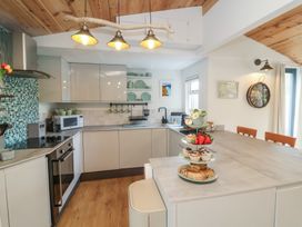A kitchen with appliances and food items at Dingle Dell Braunton