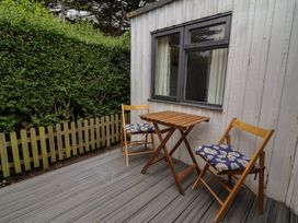 A patio with two chairs and a table at Dingle Dell in Braunton