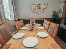 A dining room with a table set for meals at Memory Maker in Bridlington