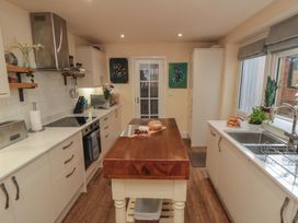 A kitchen with a counter, sink, and stove at Memory Maker in Bridlington