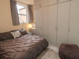 A bedroom with a bed and wardrobe at Memory Maker in Bridlington