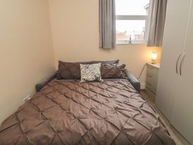 A bedroom with a bed and wardrobe at Memory Maker in Bridlington