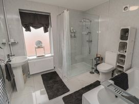 A bathroom with a shower, bathtub, and sink at Memory Maker in Bridlington