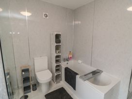A bathroom with a bathtub and toilet at Memory Maker in Bridlington