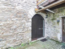 An entrance with stone wall and wooden doors at Rooftops in Lindale