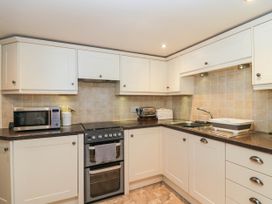 A kitchen with oven, microwave and sink at Rooftops in Lindale