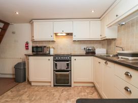 A kitchen with an oven, microwave, and sink at Rooftops Lindale