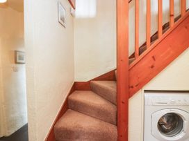 A staircase with a washing machine at Rooftops in Lindale