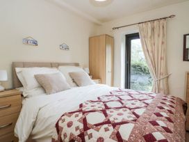 A bedroom with a bed and wardrobe at Rooftops in Lindale