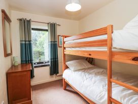 A bedroom with a bunk bed and a dresser at Rooftops in Lindale