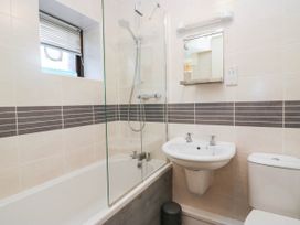 A bathroom featuring a shower, bathtub, sink, and toilet at Rooftops in Lindale